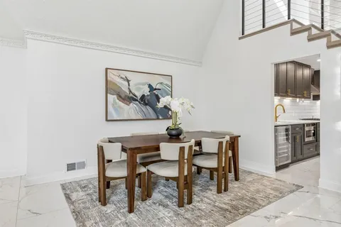 a kitchen with stainless steel appliances granite countertop a sink a stove a refrigerator and a refrigerator