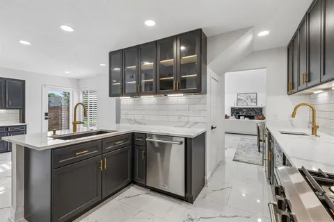 a kitchen with a refrigerator and a sink