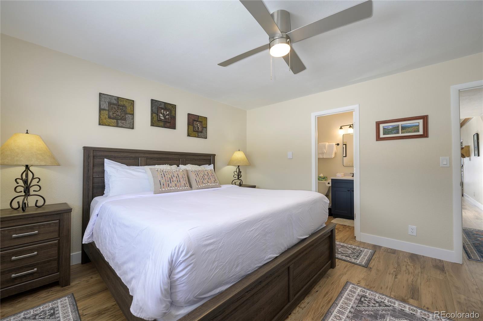 83 County Road, Unit F7 Fraser, CO 80442 - Photo 11 of 20 a bedroom with bed and wooden floor