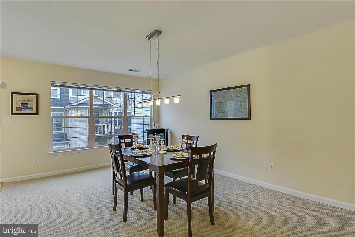 11344 King George Drive, Unit 5 Silver Spring, MD 20902 - Photo 13 of 30 a view of a dining room with furniture window and outside view