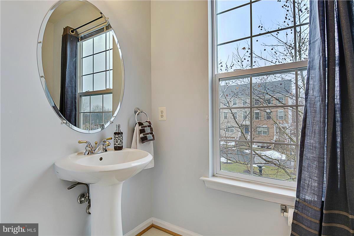 11344 King George Drive, Unit 5 Silver Spring, MD 20902 - Photo 17 of 30 a bathroom with a sink a mirror and a window