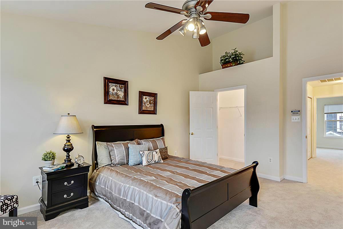 11344 King George Drive, Unit 5 Silver Spring, MD 20902 - Photo 18 of 30 a bedroom with a bed and a chandelier