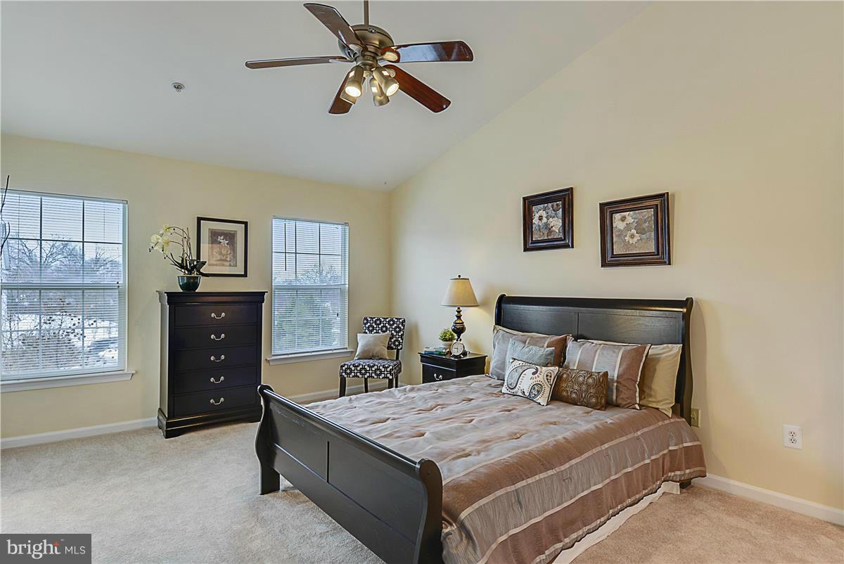11344 King George Drive, Unit 5 Silver Spring, MD 20902 - Photo 19 of 30 a bedroom with a bed and a chandelier