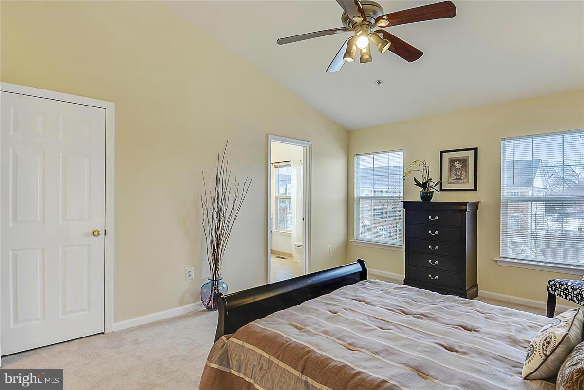 11344 King George Drive, Unit 5 Silver Spring, MD 20902 - Photo 21 of 30 a bedroom with a bed and a chandelier