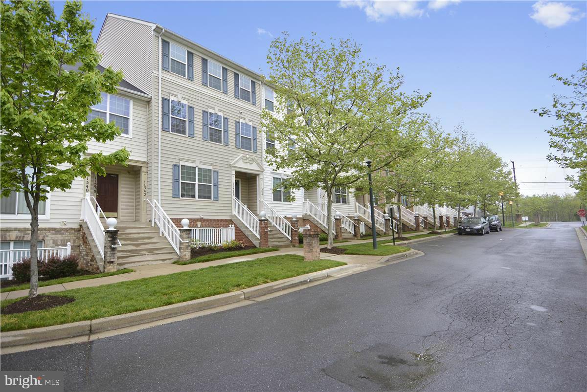 11344 King George Drive, Unit 5 Silver Spring, MD 20902 - Photo 5 of 30 a view of a house with a yard and large trees