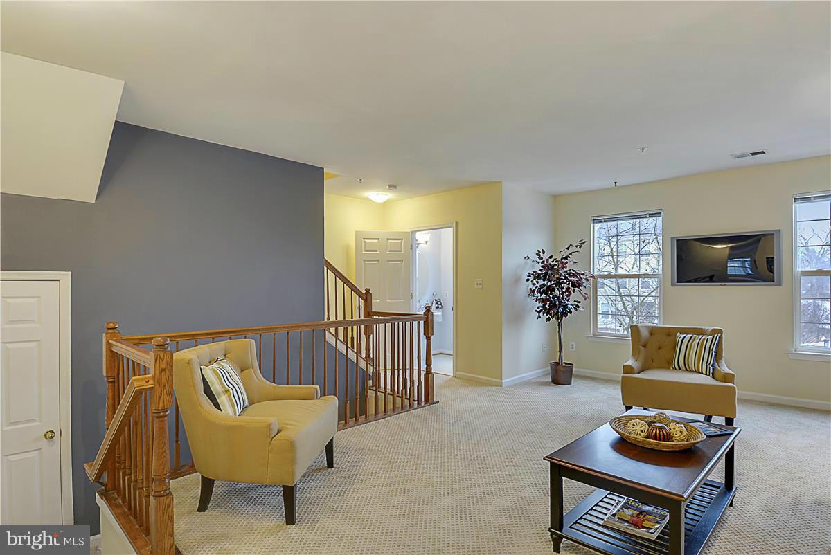 11344 King George Drive, Unit 5 Silver Spring, MD 20902 - Photo 8 of 30 a living room with furniture and a flat screen tv