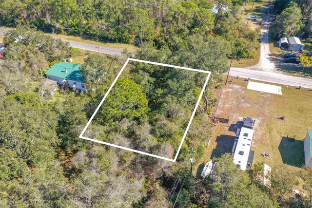 a view of a road with a house in the background