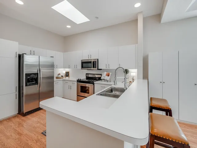 a kitchen with a sink cabinets and stainless steel appliances