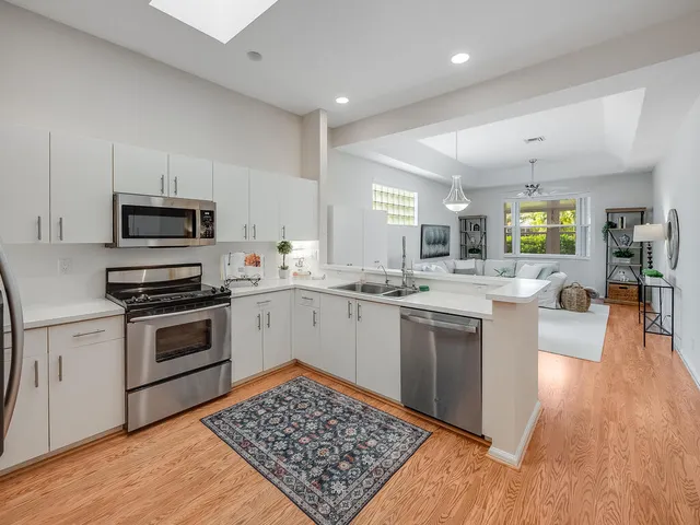 a view of bathroom with a toilet sink and mirror