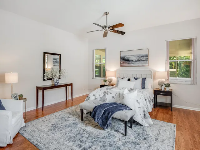 a bedroom with a bed and wooden floor