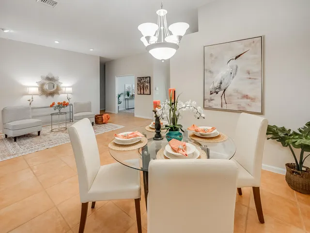 a view of a dining room with furniture and chandelier