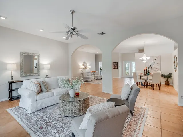 a living room with furniture and a chandelier