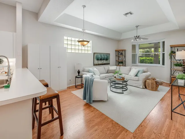 a kitchen that has a refrigerator a stove a sink and a dining table