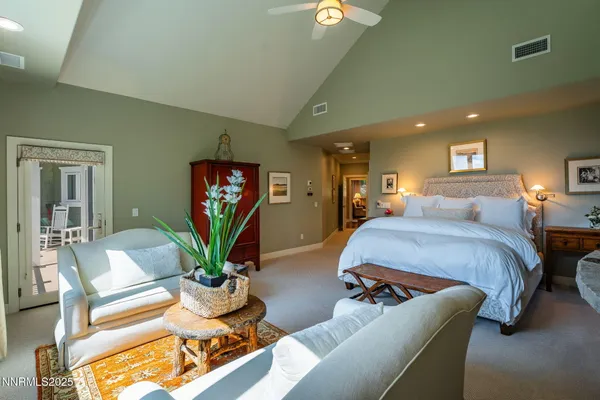 a bedroom with furniture and a potted plant