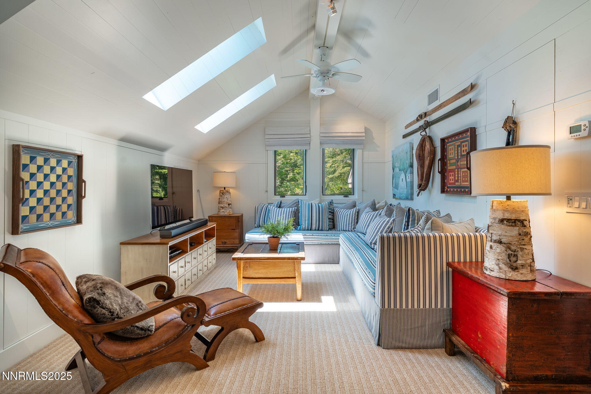 1964 Glenbrook House Road Glenbrook, NV 89413 - Photo 23 of 42 a living room with furniture a chandelier and a flat screen tv