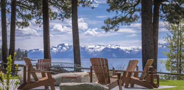 a view of a balcony with chairs potted plants and tree