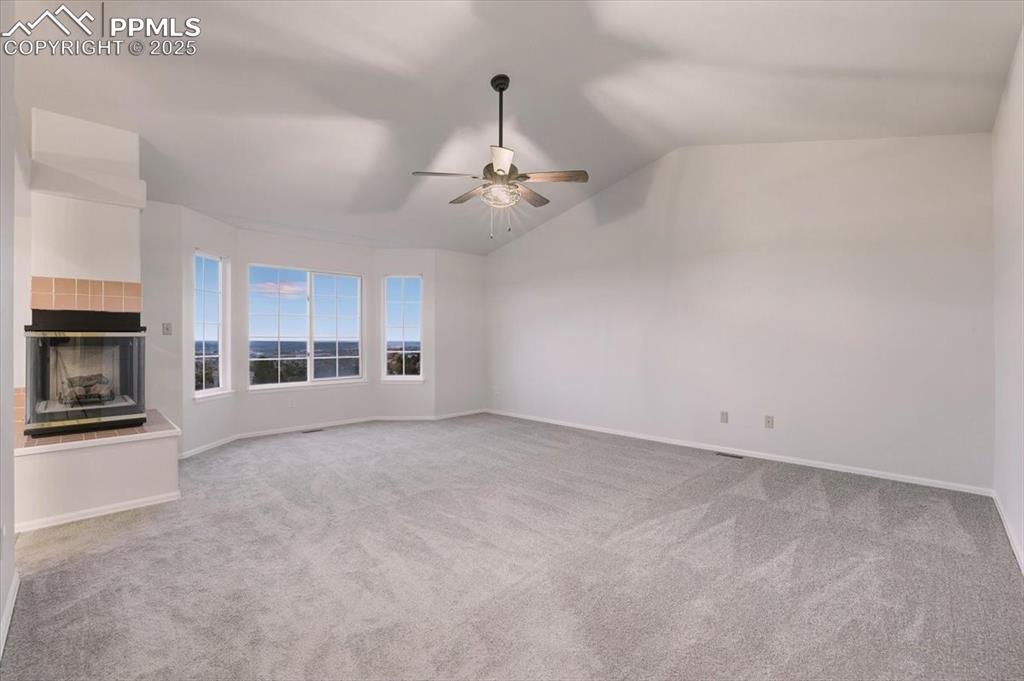 395 Cardiff Circle Colorado Springs, CO 80906 - Photo 16 of 31 a view of a livingroom with a fireplace and a ceiling fan