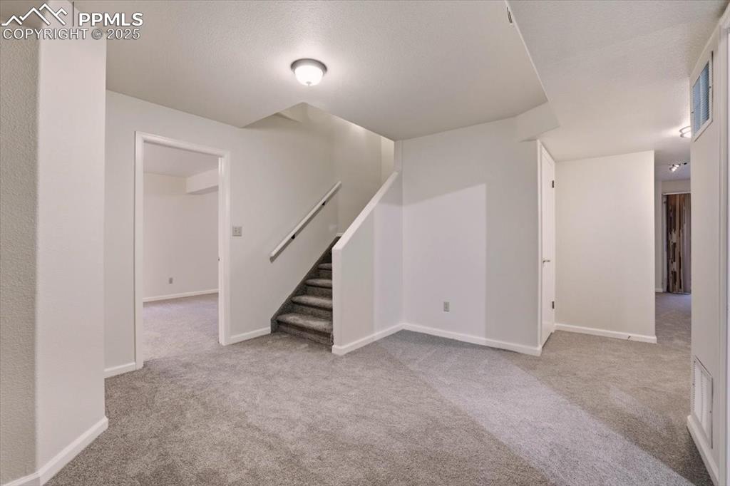 395 Cardiff Circle Colorado Springs, CO 80906 - Photo 24 of 31 a view of an empty room with stairs