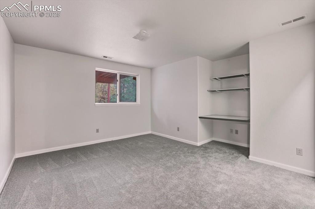 395 Cardiff Circle Colorado Springs, CO 80906 - Photo 27 of 31 a view of an empty room with a window