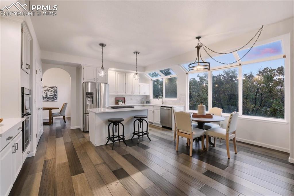 395 Cardiff Circle Colorado Springs, CO 80906 - Photo 5 of 31 a view of a dining room with furniture window and wooden floor
