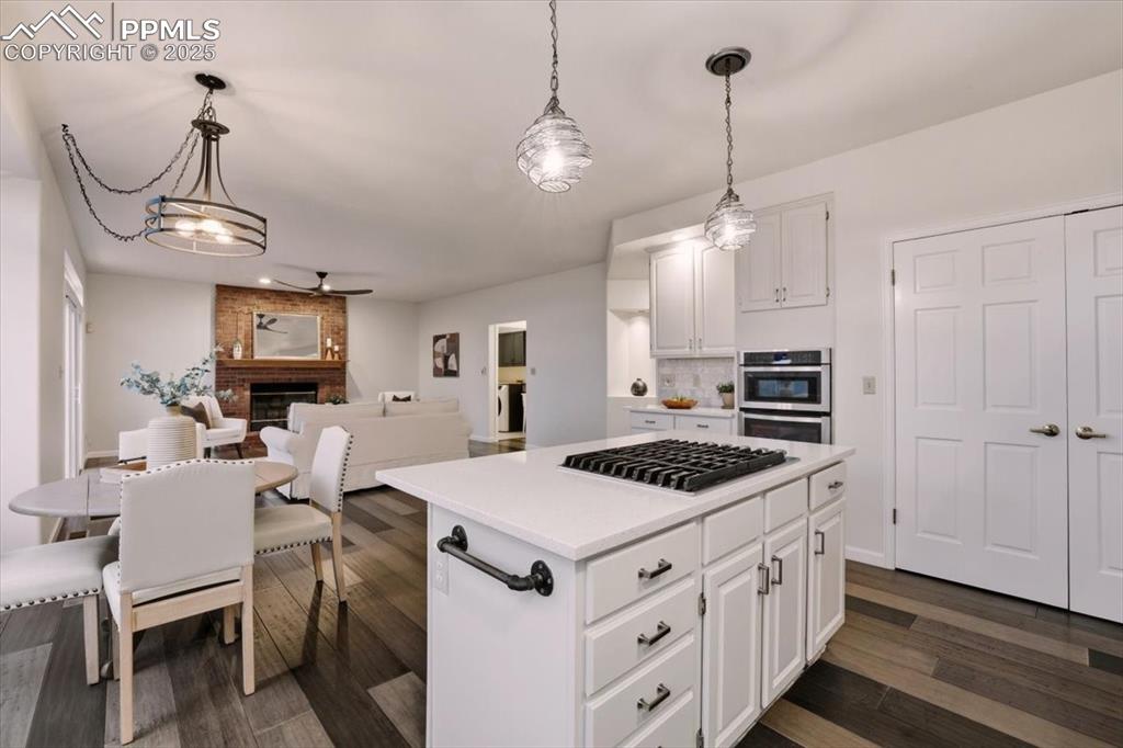 395 Cardiff Circle Colorado Springs, CO 80906 - Photo 8 of 31 a kitchen that has a stove a table and chairs in it