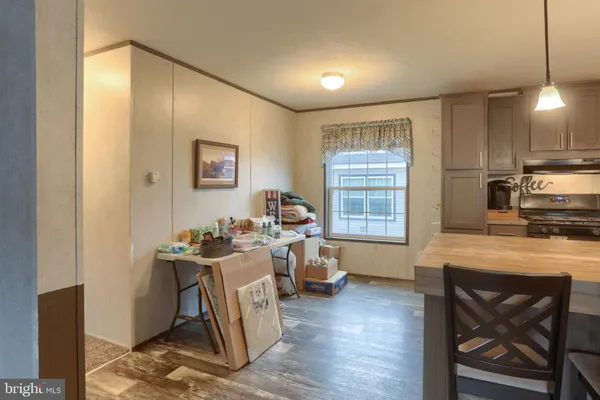 a view of a kitchen with workspace and wooden floor
