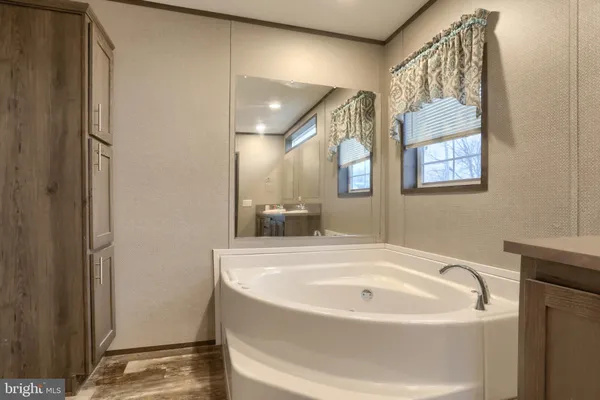 a white bath tub sitting next to a white sink