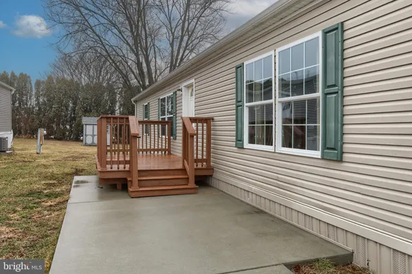 a wooden bench sitting in front of a house