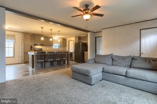 a living room with furniture and kitchen view