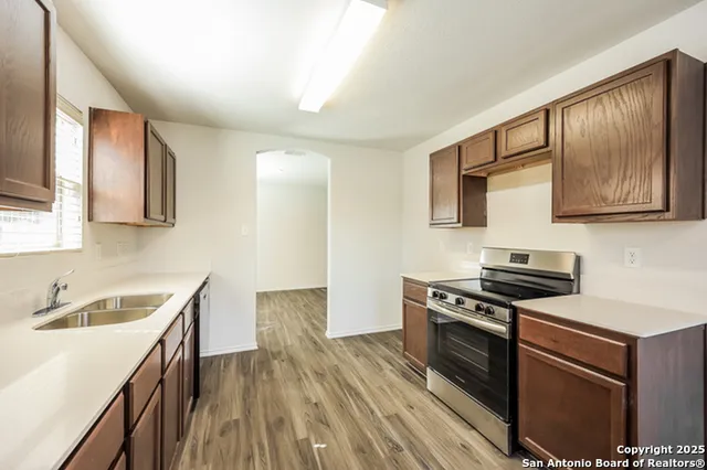 a kitchen with stainless steel appliances granite countertop a stove and a sink