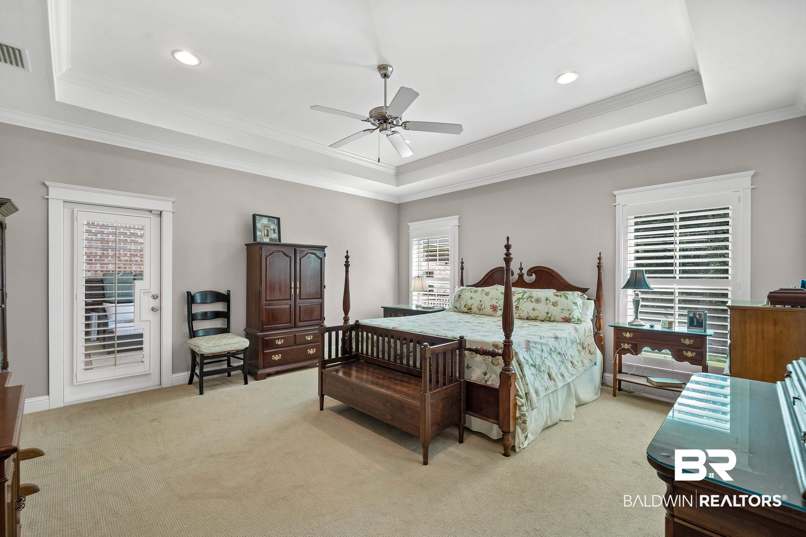 29530 St John Street Daphne, AL 36526 - Photo 14 of 38 Carpeted bedroom featuring ornamental molding, a tray ceiling, ceiling fan, and multiple windows