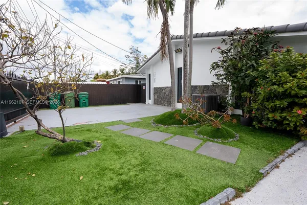 a front view of a house with garden