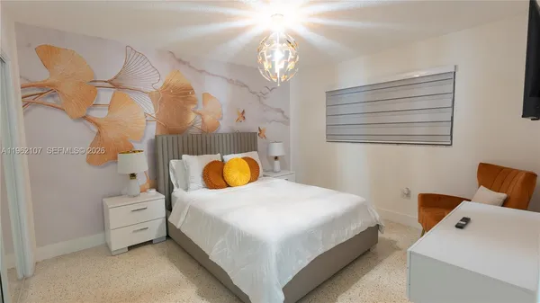 a bedroom with a bed and a flat screen tv