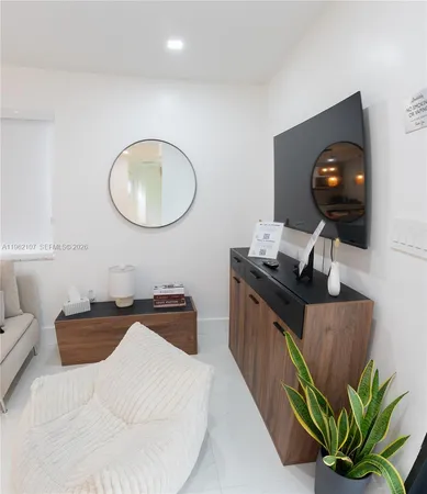 a living room with furniture a window and flowerpot