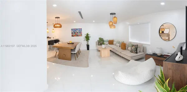a living room with kitchen island furniture and a potted plant