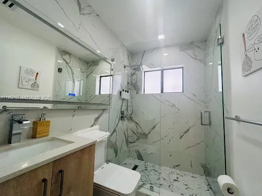 a large bedroom with a bed and a flat screen tv