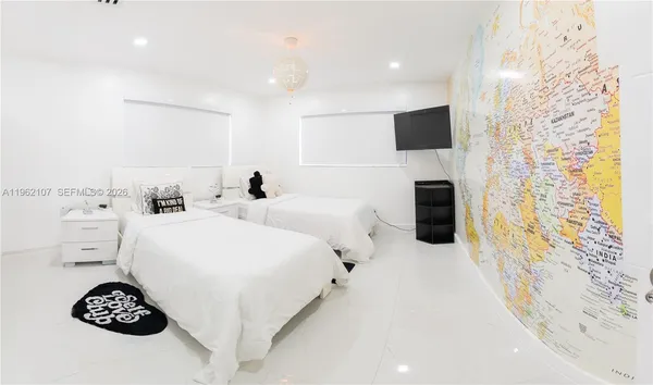 a large white bed in a white room