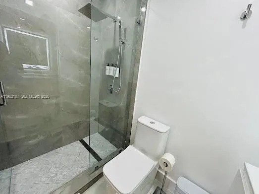 a spacious bedroom with a bed and a flat screen tv