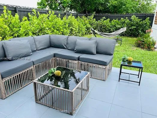 a patio with wooden table and chairs