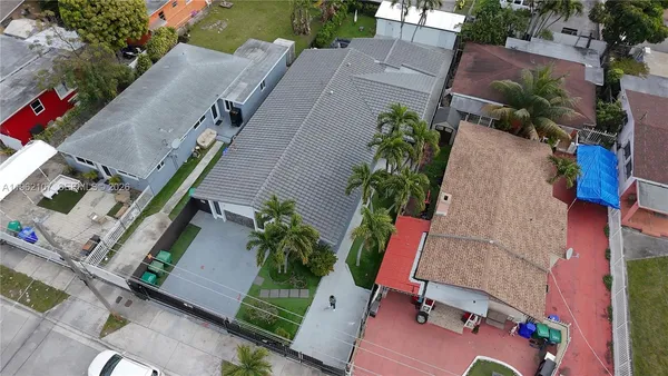 an aerial view of a house with a yard and potted plants
