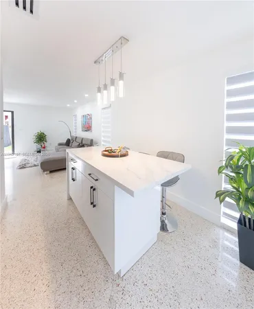 a kitchen with white cabinets stainless steel appliances and sink