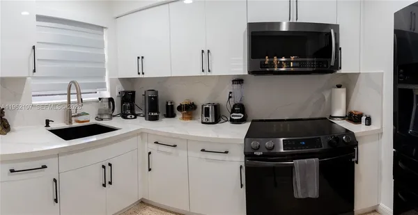 a metallic refrigerator freezer sitting in a kitchen