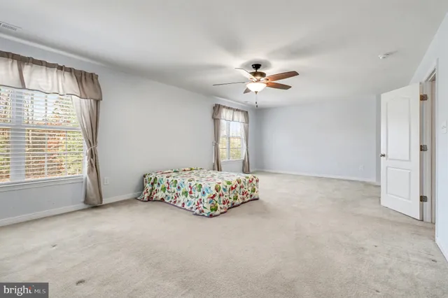 a very nice looking room with a large window chandelier and a ceiling fan