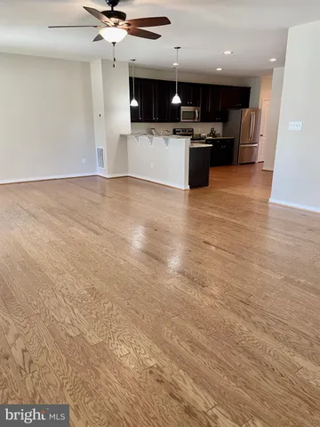 a view of kitchen with cabinets stainless steel appliances and window