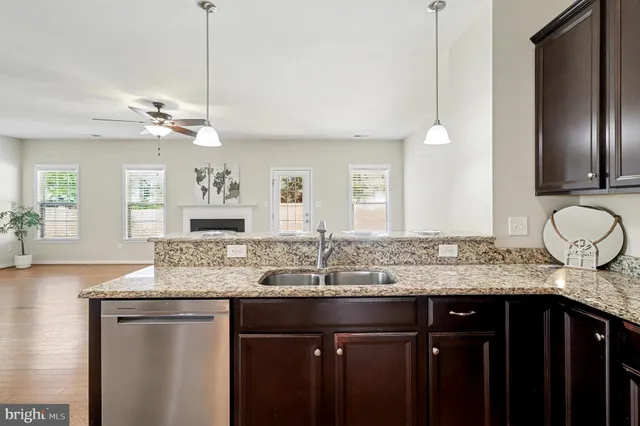 a bathroom with a granite countertop double vanity and a mirror