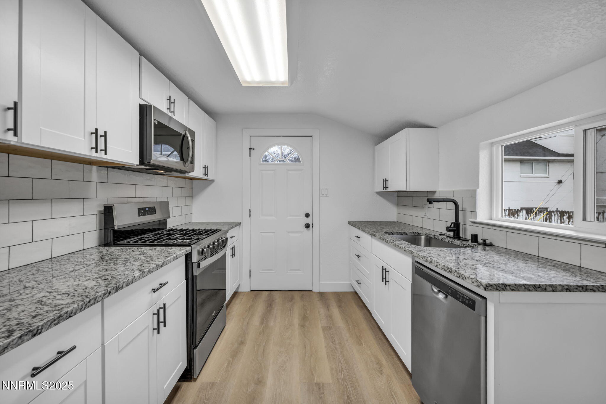1080 Bell Street Reno, NV 89503 - Photo 8 of 33 a kitchen with granite countertop stainless steel appliances a sink stove top oven and cabinets