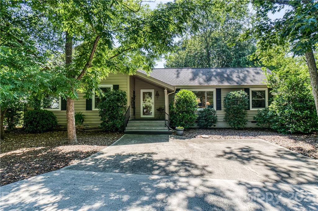 23055 Point Clear Drive, Unit 5 Tega Cay, SC 29708 - Photo 1 of 45 a front view of a house with a garden