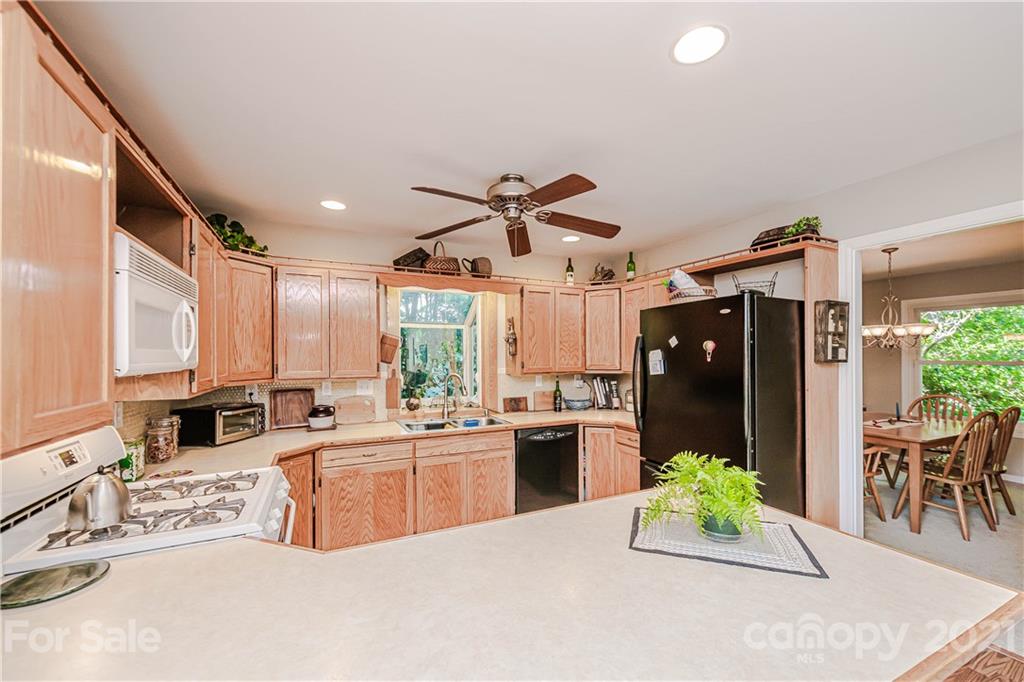 23055 Point Clear Drive, Unit 5 Tega Cay, SC 29708 - Photo 15 of 45 a kitchen with stainless steel appliances kitchen island granite countertop a refrigerator and a sink