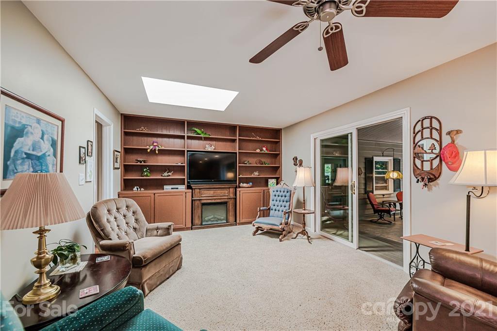 23055 Point Clear Drive, Unit 5 Tega Cay, SC 29708 - Photo 20 of 45 a living room with furniture a flat screen tv and a large window