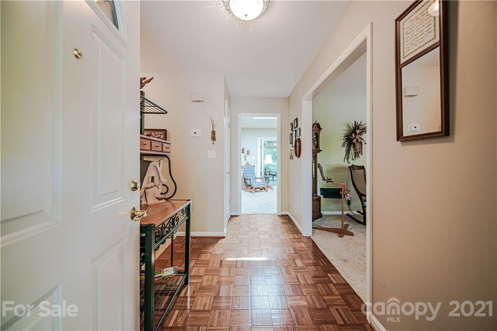 23055 Point Clear Drive, Unit 5 Tega Cay, SC 29708 - Photo 3 of 45 a hallway with a view of bedroom with wooden floor